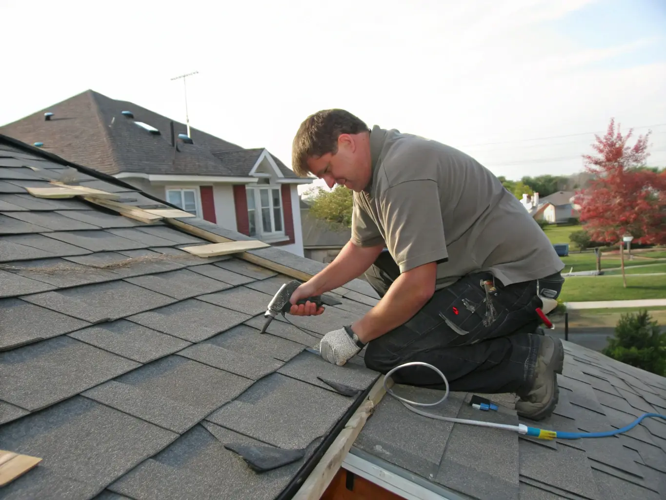 A close-up shot of a roofing technician repairing a damaged roof, highlighting the attention to detail and expertise involved in the repair process. The image should convey trust and reliability.